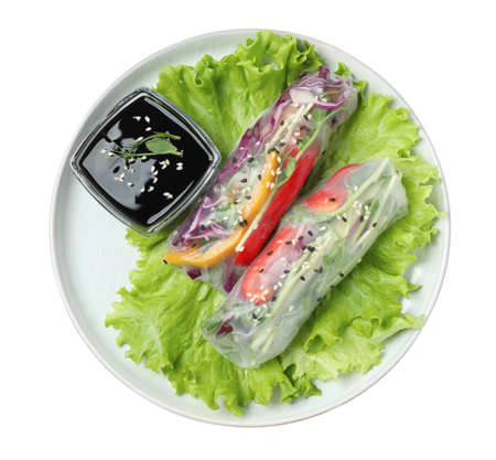 Plate with delicious rolls wrapped in rice paper and teriyaki sauce on white background, top view