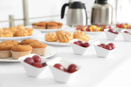 Table with different delicious snacks indoors. coffee break