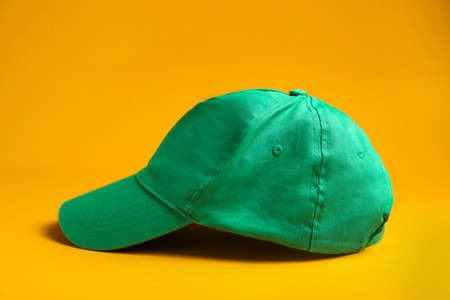 Baseball cap on yellow background. Mock up designの写真素材
