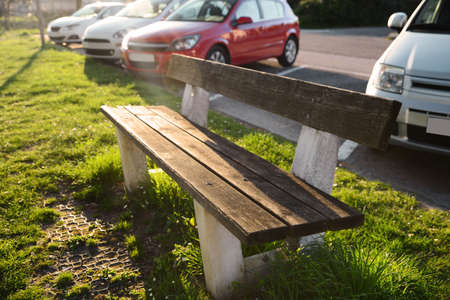 Wooden bench and green grass outdoors on sunny dayの写真素材