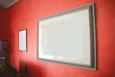 Beautiful paintings on red wall in the roomの写真素材