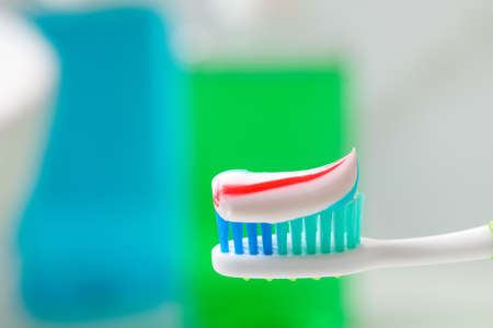 Toothbrush with paste against blurred background, closeupの写真素材