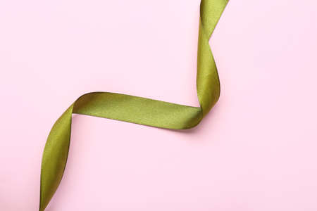 Beautiful ribbon on pink background, top view. Space for textの写真素材
