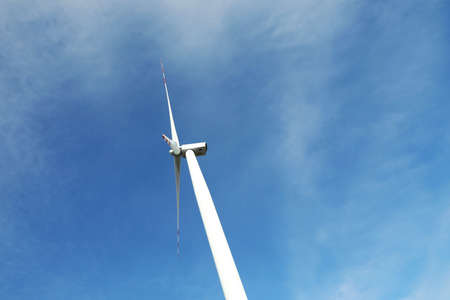 Modern wind turbine against blue sky, low angle view. alternative energy sources