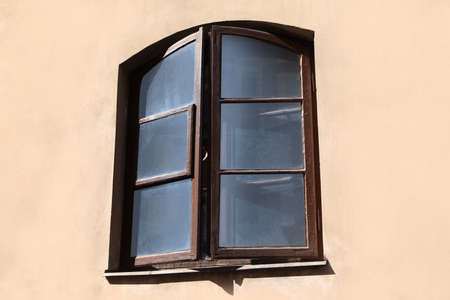 Old arched window in building, view from outdoors