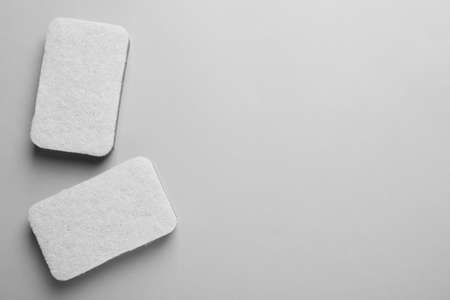 New sponges on light gray background, flat lay. Space for text