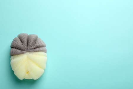 New bath sponge on light blue background, top view. Space for textの写真素材