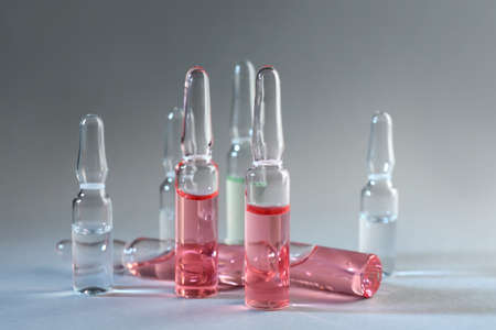 Different pharmaceutical ampoules on light gray backgroundの写真素材