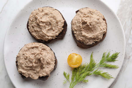 Slices of bread with delicious pate, tomato and dill on table, top viewの写真素材
