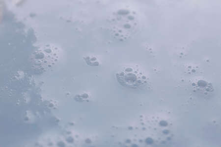 Texture of white shower gel as background, closeup