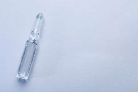 Pharmaceutical ampoule with medication on white background, top view. Space for textの写真素材