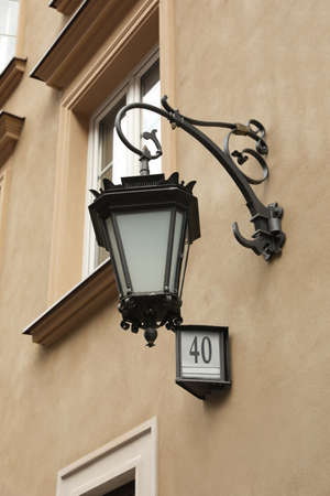 Vintage street lamp on wall of buildingの写真素材