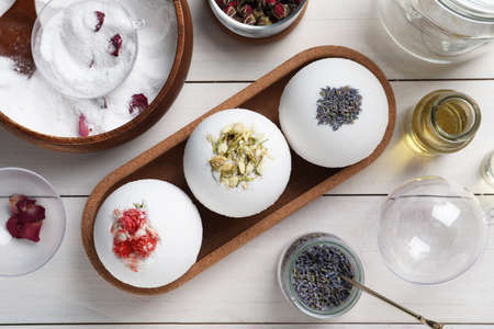Flat lay composition with bath bombs and ingredients on white wooden tableの写真素材