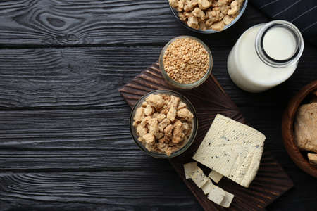 Different natural soy products on black wooden table, flat lay. Space for textの写真素材