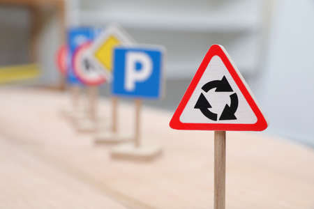 Different miniature road signs on wooden table, closeup with space for text. Montessori toyの写真素材