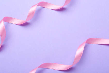 Beautiful pink ribbons on light background. Space for textの写真素材