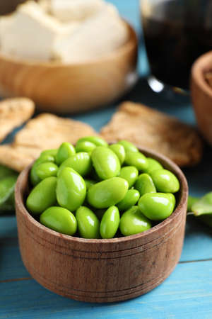 Fresh green soy beans and other organic products on light blue wooden table, closeupの写真素材