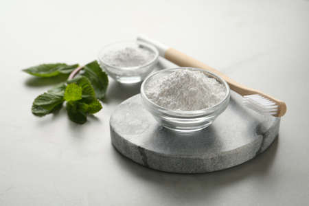 Tooth powder, brush and mint on gray tableの写真素材