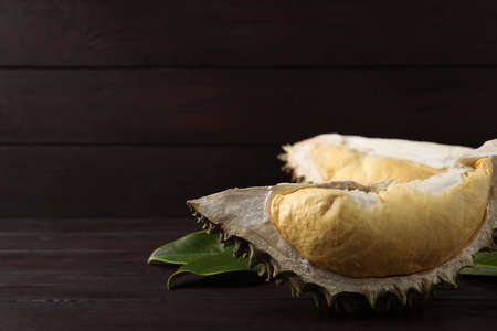 Fresh ripe durian on wooden table. Space for text