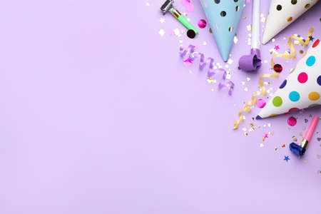 Beautiful flat lay composition with festive items on violet background, space for text. Surprise party conceptの写真素材