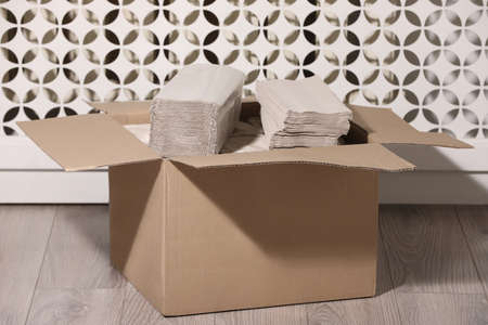 Cardboard box with paper napkins on floor indoorsの写真素材