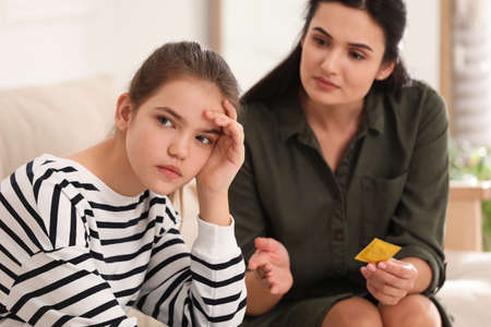 Mother talking with her teenage daughter about contraception at home. sex education conceptの写真素材