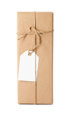 Gift box wrapped in kraft paper with bow and tag isolated on whiteの写真素材