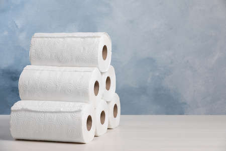 Many rolls of paper towels on white wooden table. Space for textの写真素材
