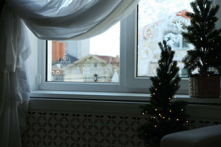 Beautiful drawing made of artificial snow on window at home. christmas decor