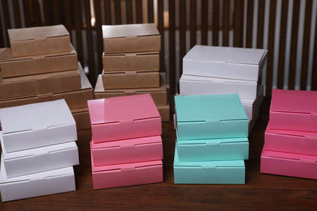 Stacked packaging boxes on wooden table indoors. production line