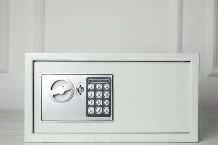 Steel safe with electronic lock on wooden tableの写真素材