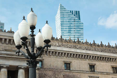 Old fashioned street light lamp near building against cloudy skyの写真素材