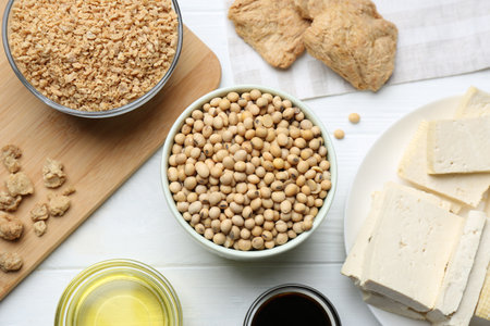 Different natural soy products on white wooden table, flat layの写真素材