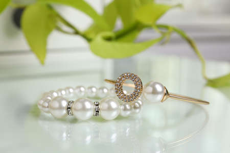 Elegant bracelets with pearls on white table, closeupの写真素材