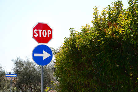 Road signs STOP and PROCEED RIGHT ONLY outdoors