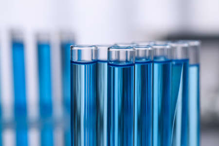 Test tubes with reagents on blurred background, closeup. laboratory analysisの写真素材