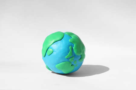 Planet Earth model made of colorful plastic on white backgroundの写真素材