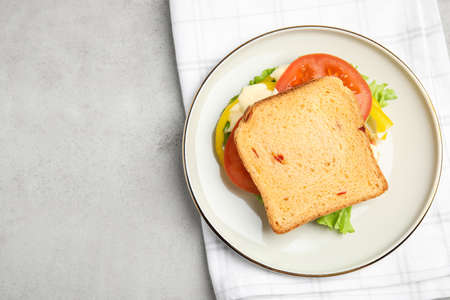 Delicious sandwich with vegetables and mayonnaise served on light gray table, top view. Space for textの写真素材
