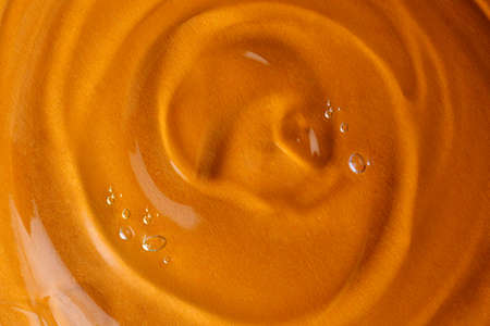 Sample of transparent shower gel on orange background, closeupの写真素材