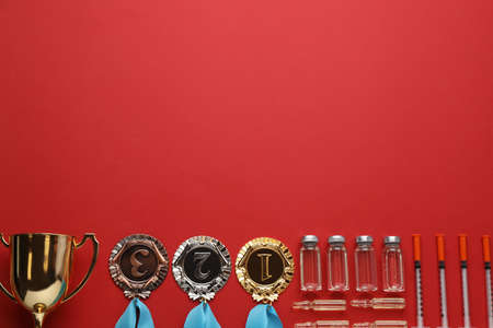 Flat lay composition with drugs on red background, space for text. doping controlの写真素材