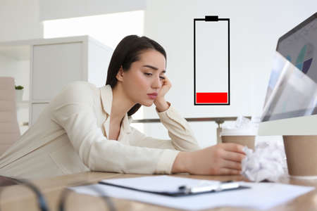 Illustration of discharged battery and tired woman at workplace in office. extreme fatigueの写真素材