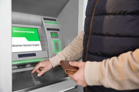 Man entering cash machine pin code, closeup