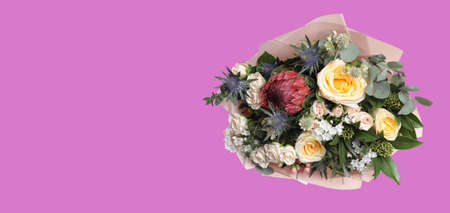 Bouquet with beautiful roses on violet background, space for text. banner designの写真素材