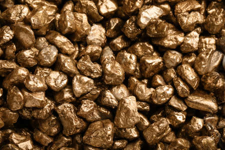 Pile of gold nuggets as background, closeup