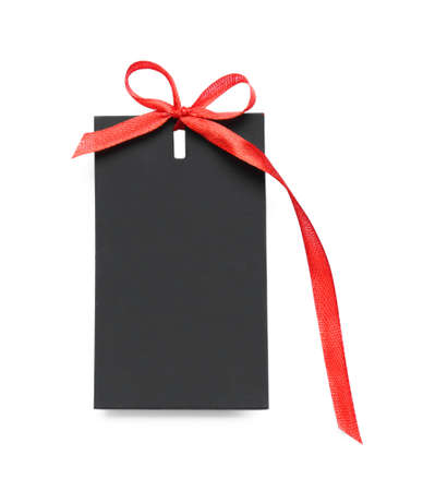 Blank black gift tag with red satin ribbon on white background, top view. space for design