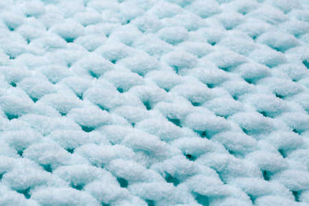 Soft light blue knitted fabric as background, closeup