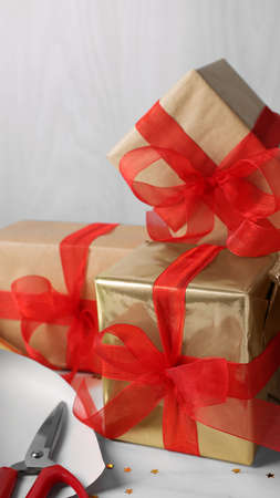 Beautifully wrapped gift boxes on white table, closeup