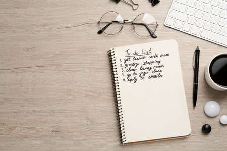 Flat lay composition with to do list on wooden table, space for text