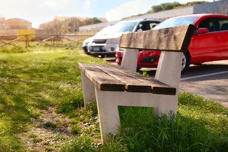 Wooden bench and green grass outdoors on sunny dayの写真素材