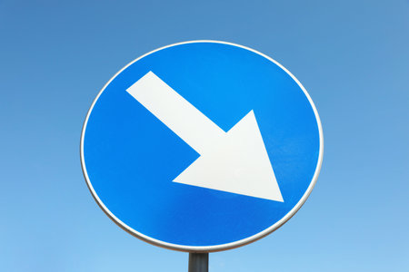 Traffic sign Keep Right against blue sky, low angle viewの写真素材